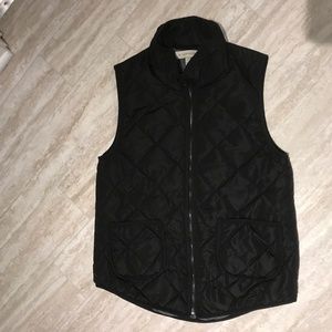 Black puffy zip up vest.
